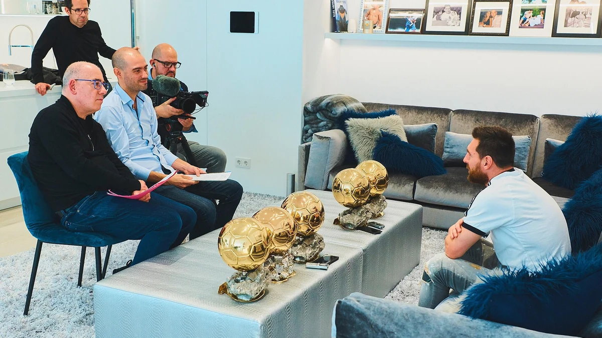 Lionel Messi interviewed at home alongside his Ballon d'Or trophies. Photo: Florent Torchut / Wikimedia Commons (CC BY-SA 4.0).